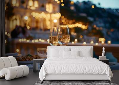 A table with two wine glasses and a plate of food Wall mural