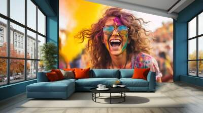 Portrait of smiling young woman wearing sunglasses covered with holi color Wall mural