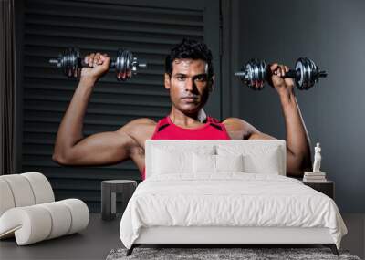 Athletic Indian man exercising with dumbbells Wall mural