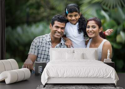 Happy Indian family at the park. Wall mural