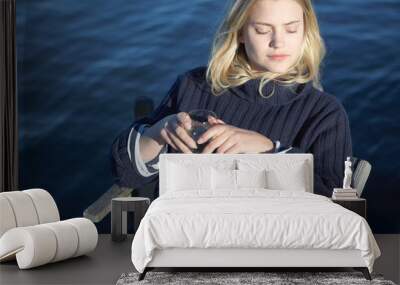 Young Woman relaxing on jetty Wall mural