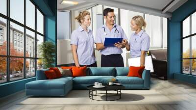 young doctor with two nurses Wall mural