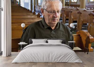 Senior man reading a bible in church Wall mural