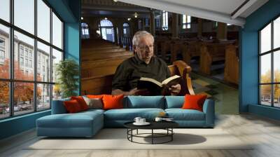 Senior man reading a bible in church Wall mural