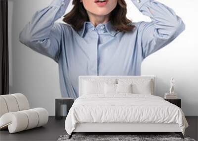 A surprised woman in formal wear with her hands on her head, isolated on a white background. Photography concept Wall mural