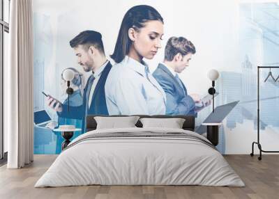 Business team with gadgets in city Wall mural