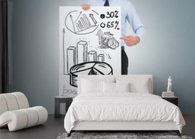 Businessman holding a graphs poster Wall mural