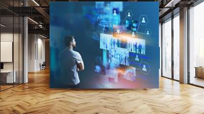 Casual man looking at virtual screens Wall mural