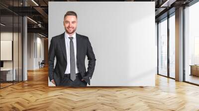 Happy businessman portrait hands in pocket on empty white background Wall mural