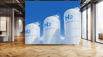 Large storage tanks with H2 and HYDROGEN labels on a blue sky background, representing hydrogen energy storage concept. 3D Rendering Wall mural