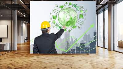 man in front of eco energy icons, clean environment Wall mural