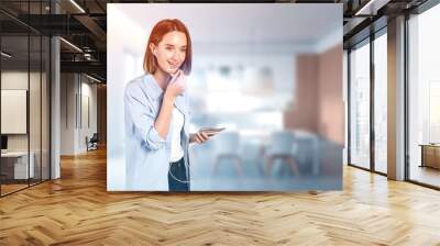 Smiling teen girl talking on phone in kitchen Wall mural