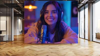 Smiling woman with headphones in a cozy home studio. Wall mural