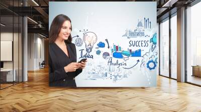 Smiling young attractive businesswoman wearing formal suit is ho Wall mural