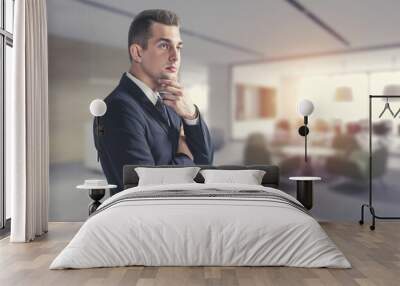 Thoughtful young businessman in office, side view Wall mural