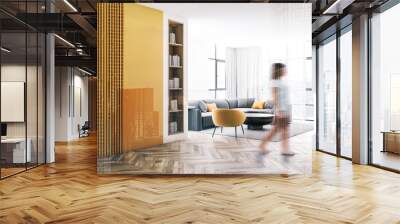 Woman walking in white and yellow living room Wall mural