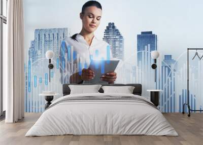 Woman with tablet in city and graphs Wall mural