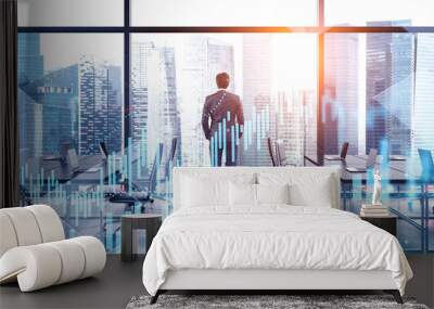 Young broker working in office, digital graphs Wall mural