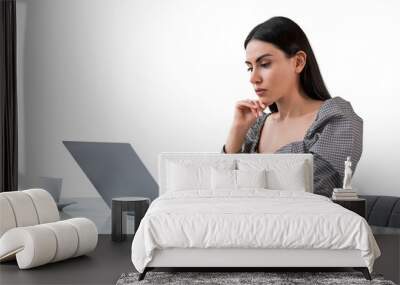 Young businesswoman with laptop thinking, isolated over white ba Wall mural