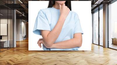 Young woman in casual light blue outfit posing confidently on wh Wall mural