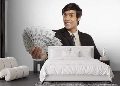 Businessman holding money Wall mural