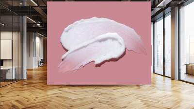 White cosmetic cream lotion swatch smear smudge on pink color background. Wall mural