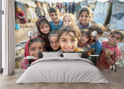 Group of children in a refugee camp take a selfie together, smiling brightly Wall mural