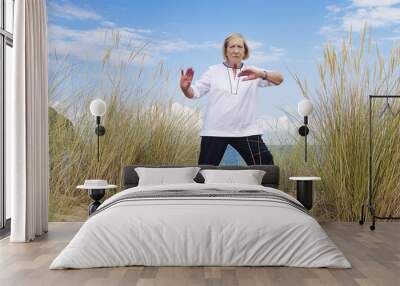 An old woman practicing Tai Chi Wall mural