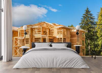 Apartment building under construction with two timber trunks on side Wall mural