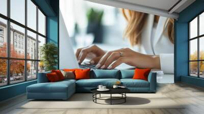 Close-up of businesswoman s hand typing on a laptop, representing success, no face shown Wall mural