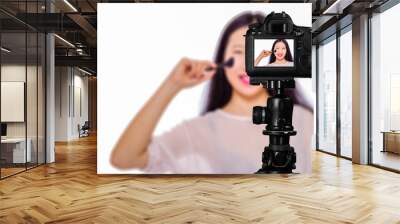 Focus on live view on camera on tripod, teenage girl   with blurred scene in background. Teenage vlogger livestreaming show concept Wall mural