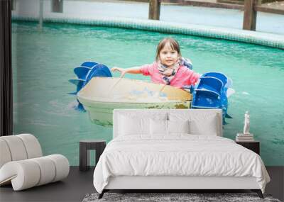 Young girl in a pedal boat Wall mural