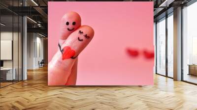 valentine's day, Happy couple in love. 2 fingers holding red heart while smiling face with hearts bokeh background. happy couple in love with painted smiley and hugging. copy space Wall mural