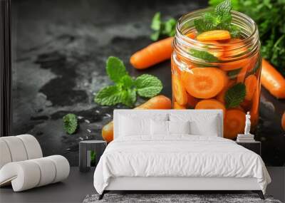 sliced carrots in a jar filled with water with mint leaves. Wall mural