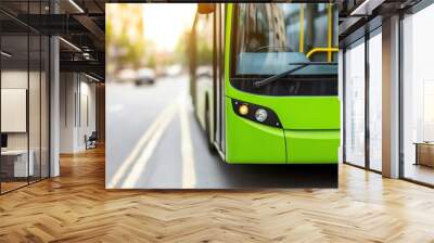 Close-up view of a modern green bus on an urban street, showcasing its sleek design and eco-friendly features. Wall mural