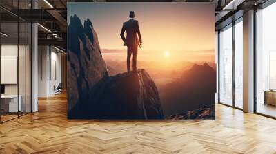 businessman look the sunlight on the top of mountain with over orange sky and sunlight.concept of leadership successful achievement with goal,growth,up,win and objective target. (ai generated) Wall mural