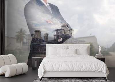 Double exposure of Businessman arms crossed and stand up and electric generating factory as energy and thinking vision of leader concept. Wall mural