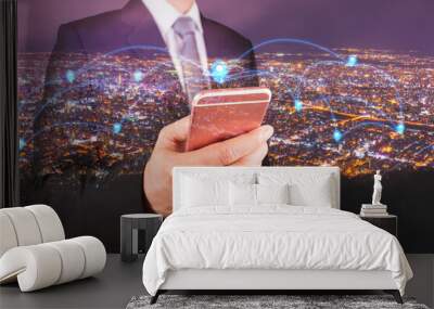 Double exposure of businessman use smartphone, communication 4G 5G node networking telephone cellsite and cityscape urban in the night as business, technology and telecom concept Wall mural