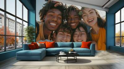 A group of four diverse students, two guys and two girls, smile and look at the camera for a selfie Wall mural