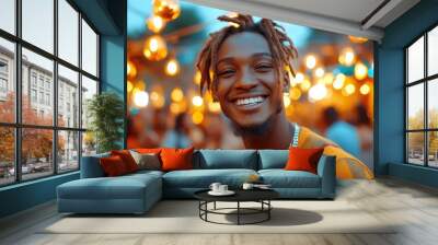 A man with dreadlocks is smiling at the camera. He is wearing an orange shirt and a necklace Wall mural