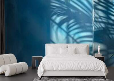 A palm tree casting a shadow on a light blue wall Wall mural