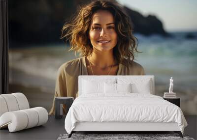 A portrait of a happy young woman with brown hair on a beach at sunset Wall mural