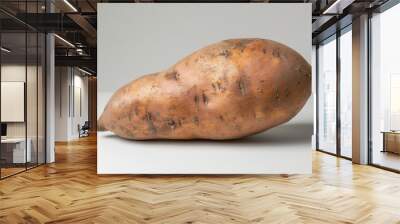 A whole sweet potato isolated on a white background Wall mural