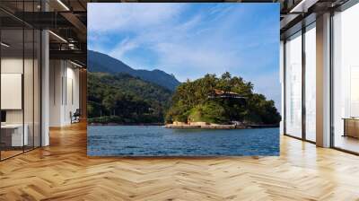 Panoramic view with island,  mountain and blue sky on sunny summer day in Ilha Bela on the coast of São Paulo, Brazil. Wall mural