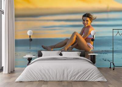 Girl on the beach at sunset Wall mural