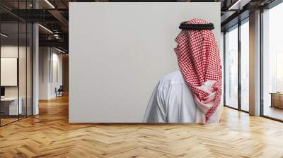 isolated image of a gulf arab man seen from behind on a white background Wall mural