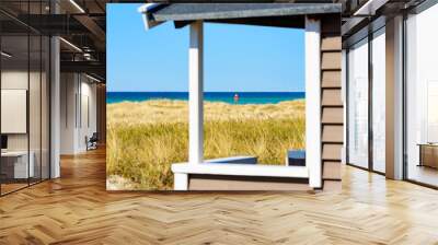 Close up of pale brown and white beach hut opening with the horizon over water in the distance. Focus on the horizon and the things in the distance, shack out of focus. Copy space. Wall mural