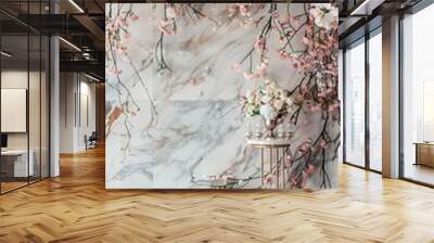 White marble wall with pink and white floral garland on top, floor to ceiling vertical bar counter display stand made of thin metal bars, backdrop wall covered in gray rose gold marble, romantic weddi Wall mural