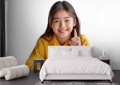 Confident Asian teenage girl showing something sitting at the table isolated on transparent background Wall mural