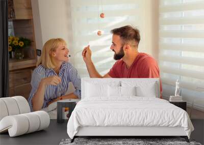 Couple having breakfast feeding each other Wall mural